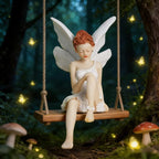 Dkor Ltd whimsical fairy figurine with white wings and dress, sitting on a wooden swing in a magical forest setting with glowing butterflies.